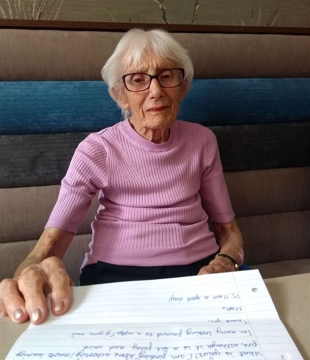 Tonbridge House Care Home resident, Jean, reading letters written by students from The Hayesbrook School