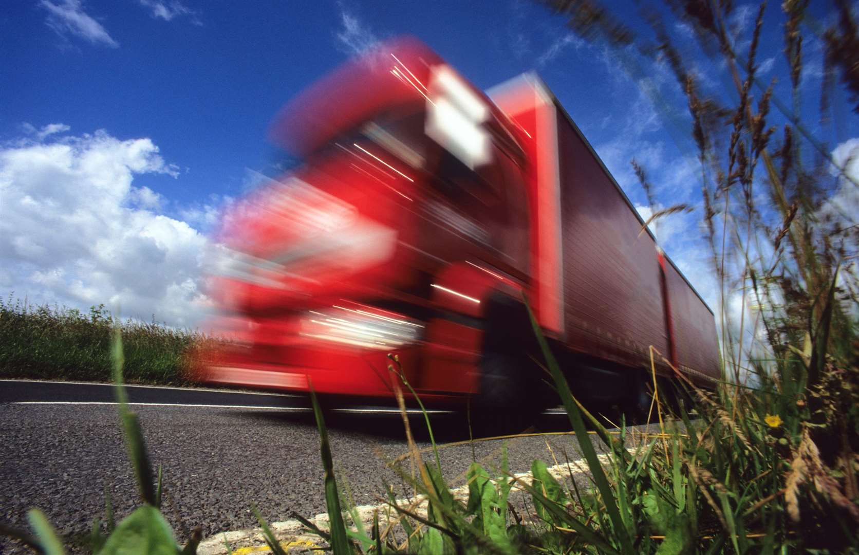 A lorry travelling on a country road. Stock picture