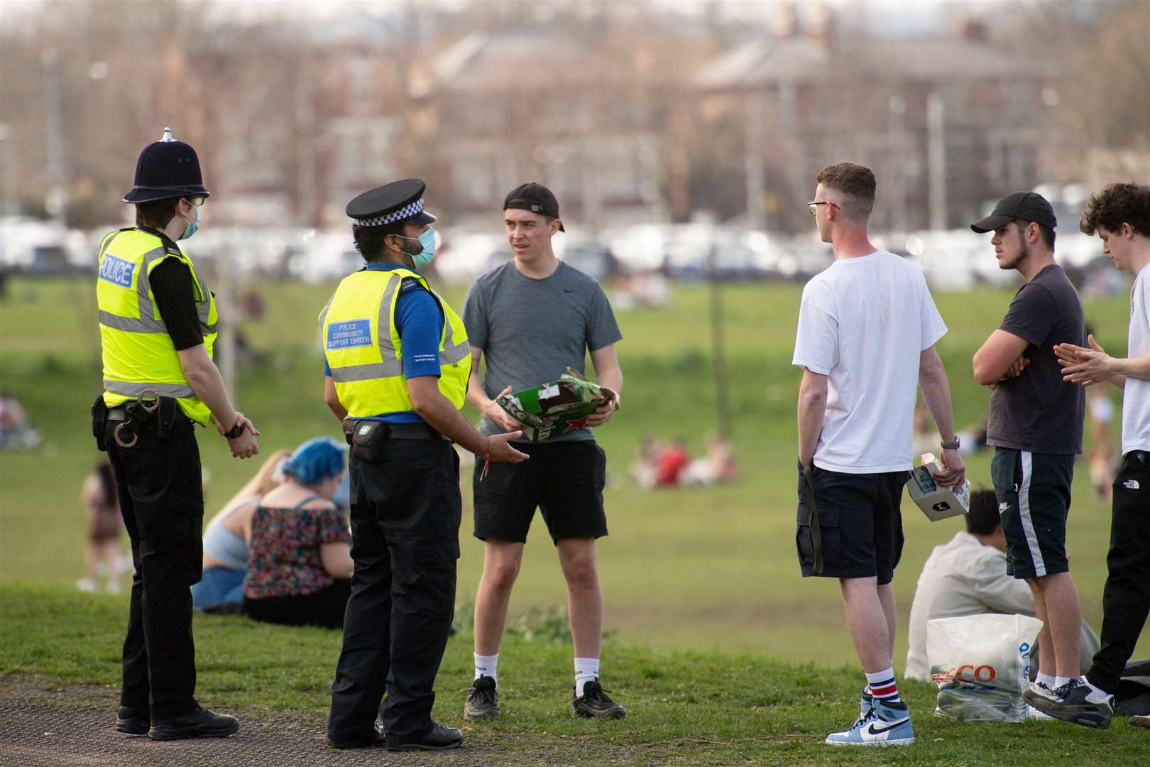 Police officers talk to a group of people at the Forest Recreation Ground (Jacob King/PA)