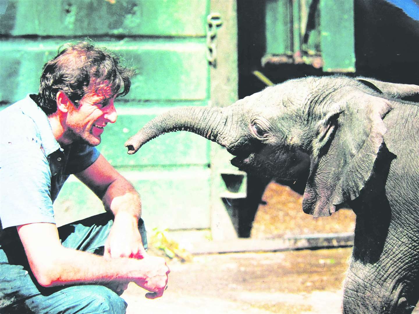 Former keeper Dave Magner with a baby elephant