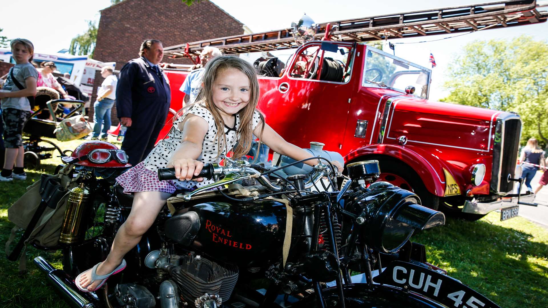 Megan Sinden, six, takes a ride on a 1941 Royal Enfield motorbike