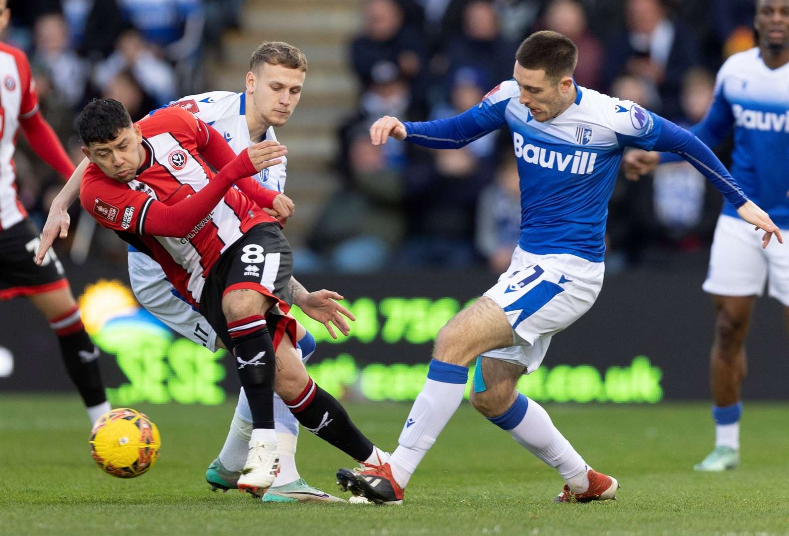 Dom Jefferies and Ethan Coleman challenge for the ball during Gillingham’s FA Cup defeat to Premier League Sheffield United. Picture: @Julian_KPI