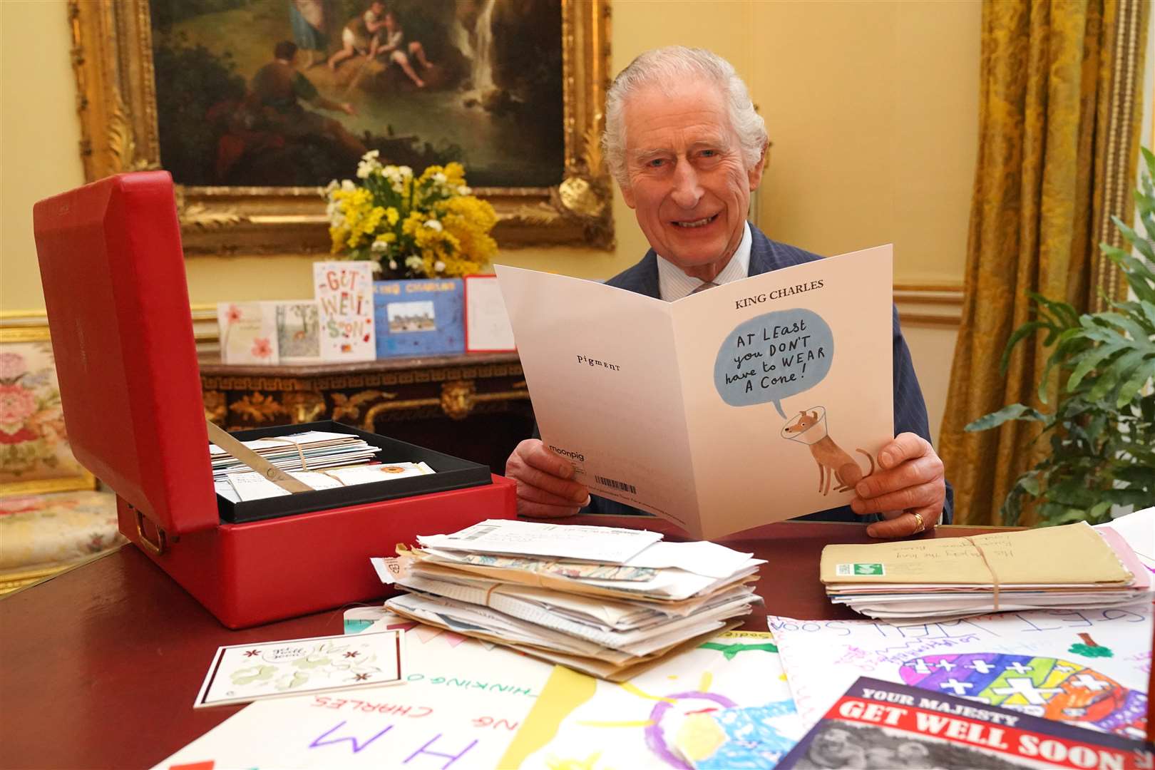 The King reads cards and messages, sent by well-wishers, following his cancer diagnosis (Jonathan Brady/PA)