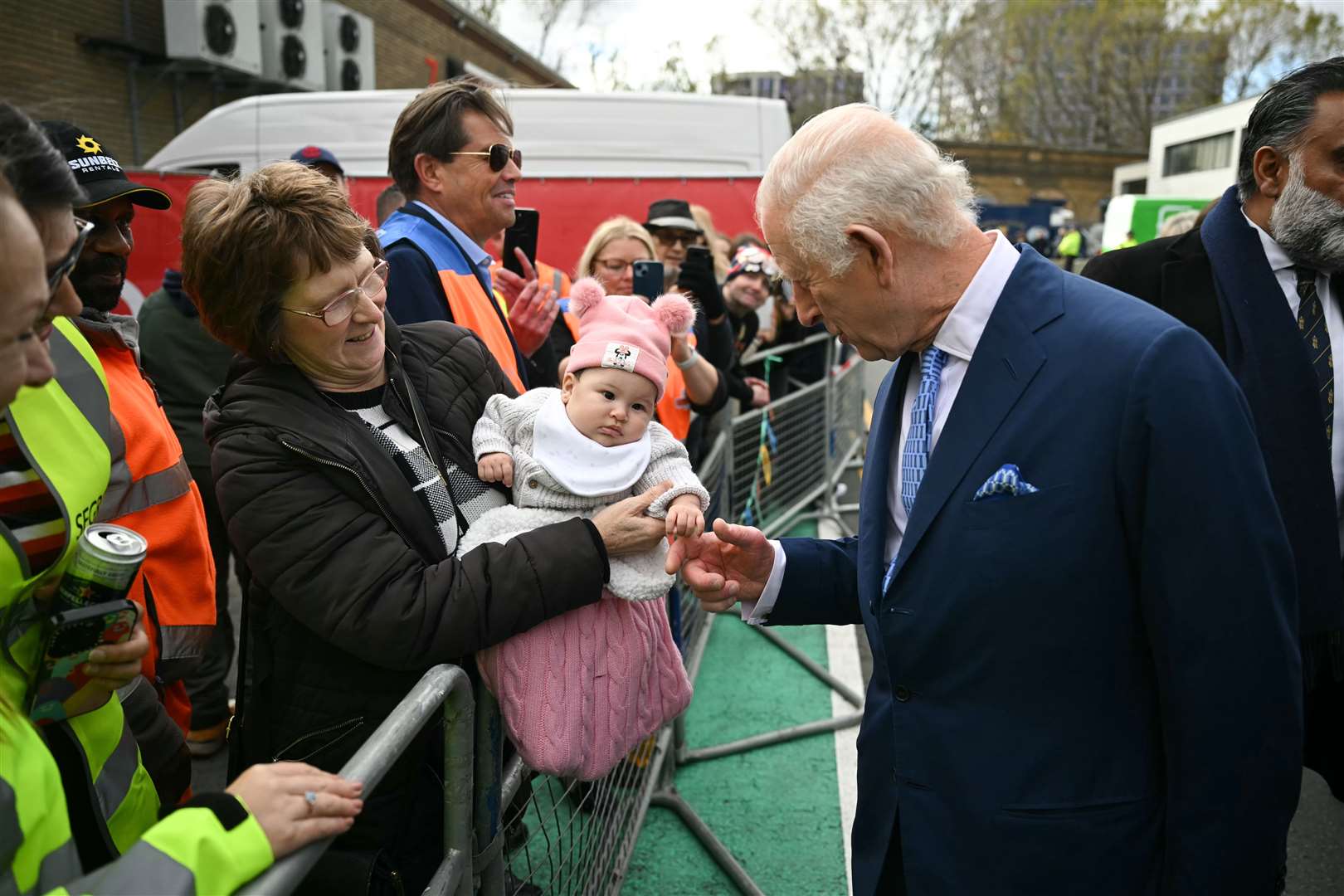 Charles greets a baby during a visit to Deptford, south-east London, on his 76th birthday (Justin Tallis/PA)