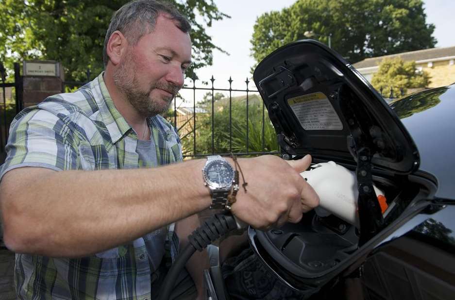 Commuter Darren Bramley charging his Nissan Leaf