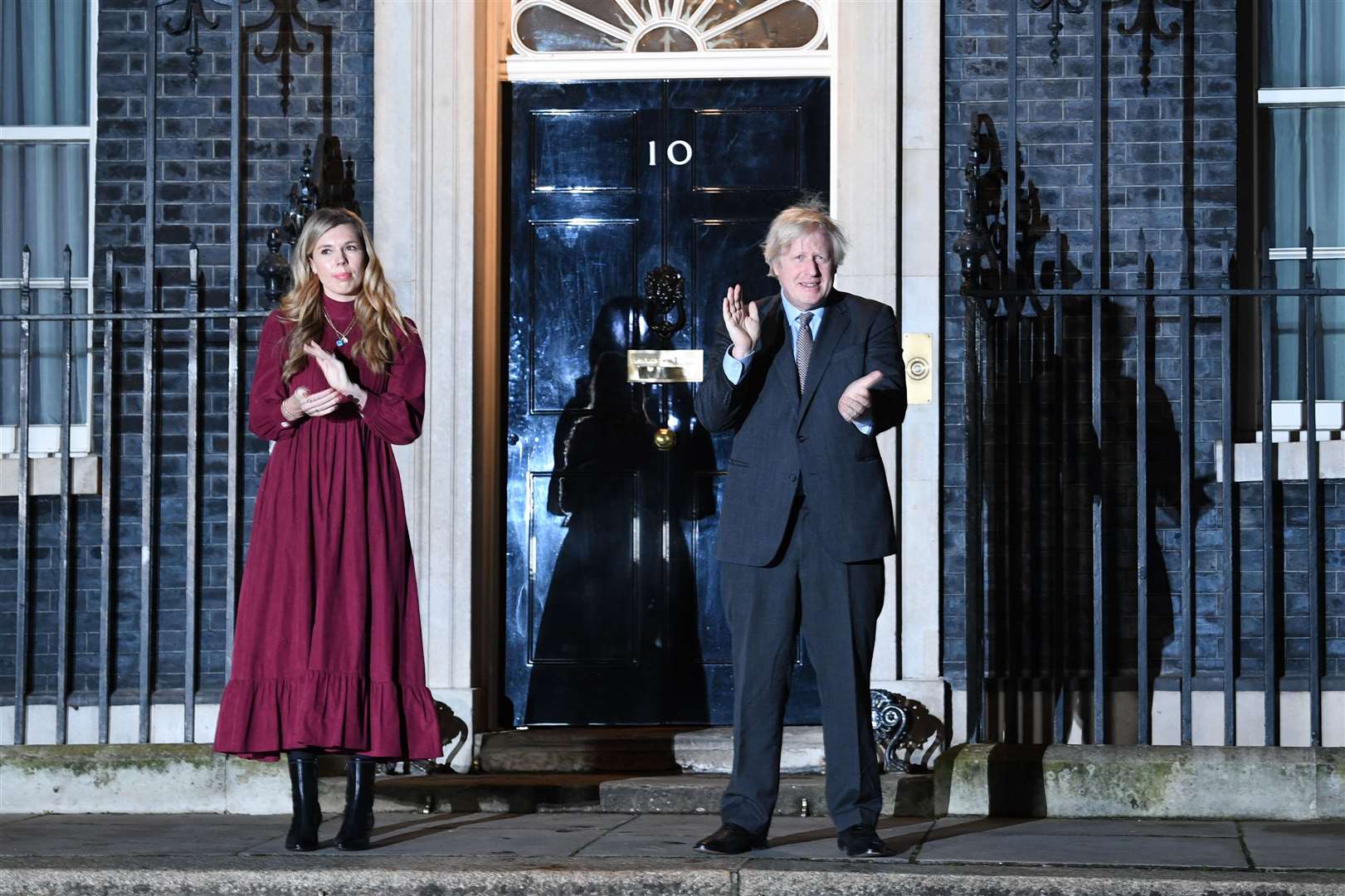 Prime Minister Boris Johnson and his partner Carrie Symonds stand outside 10 Downing Street to join in with a nationwide clap in honour of Captain Sir Tom Moore (Stefan Rousseau/PA)