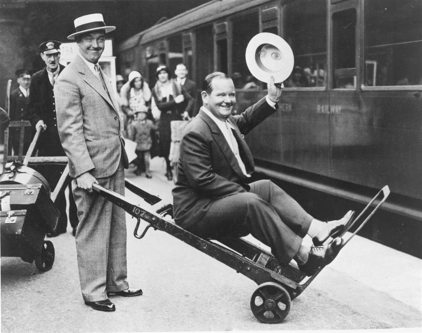 Comedy legends Laurel & Hardy lark about at Waterloo station