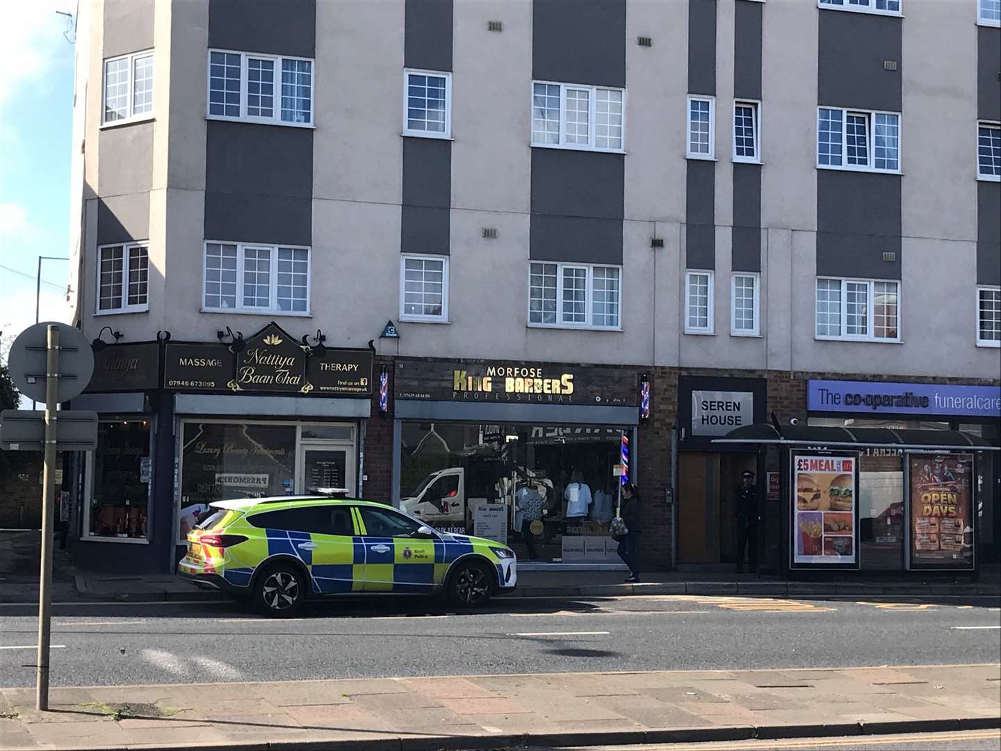 Police parked outside a Thai massage parlour and a barbers in Strood after a stabbing