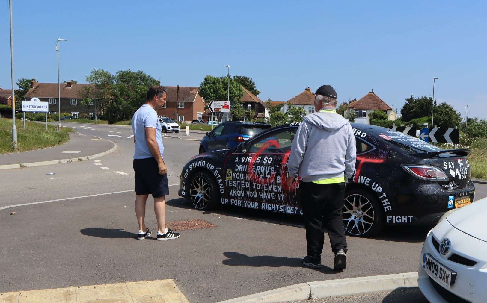 Gary Townsend, left, one of many who turned up to look at the 'anti-covid' car parked at the Lower Road roundabout, Minster, Sheppey on Sunday