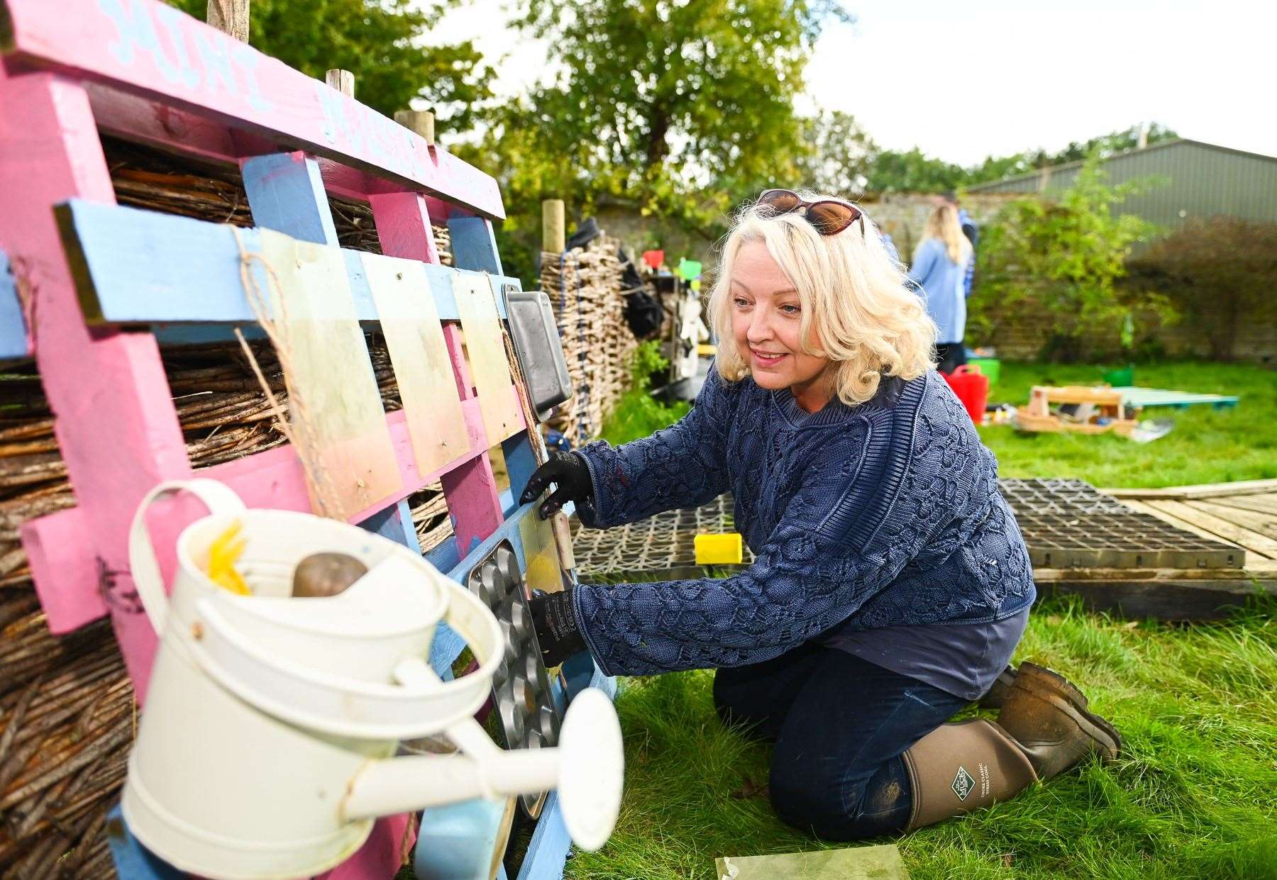 Lottery winner Maxine Tilbury helps spruce up a garden for toddlers at Sacrewell Farm in Peterborough (National Lottery/ PA)