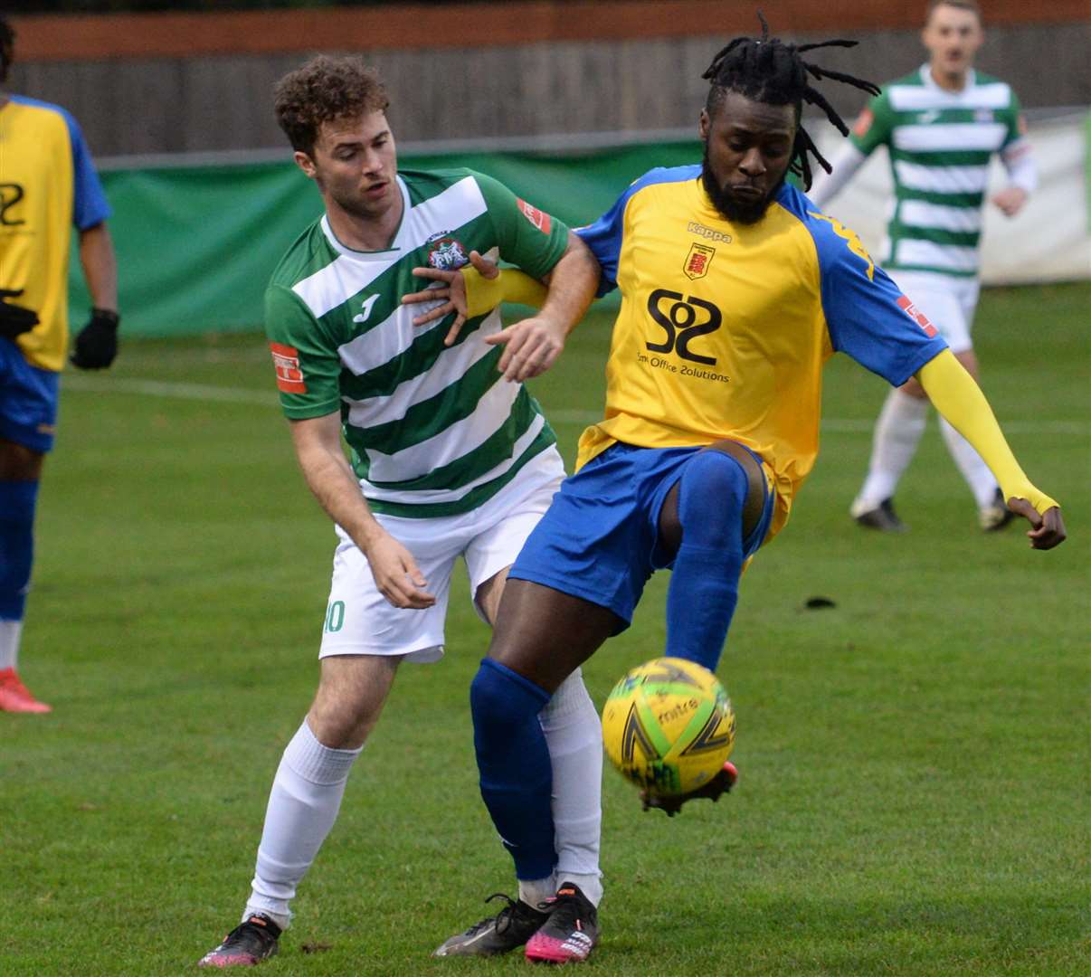 Faversham's Bola Dawodu holds off Corinthian's Oscar Housego during the away team's 1-0 win at Gay Dawn Farm. Picture: Chris Davey