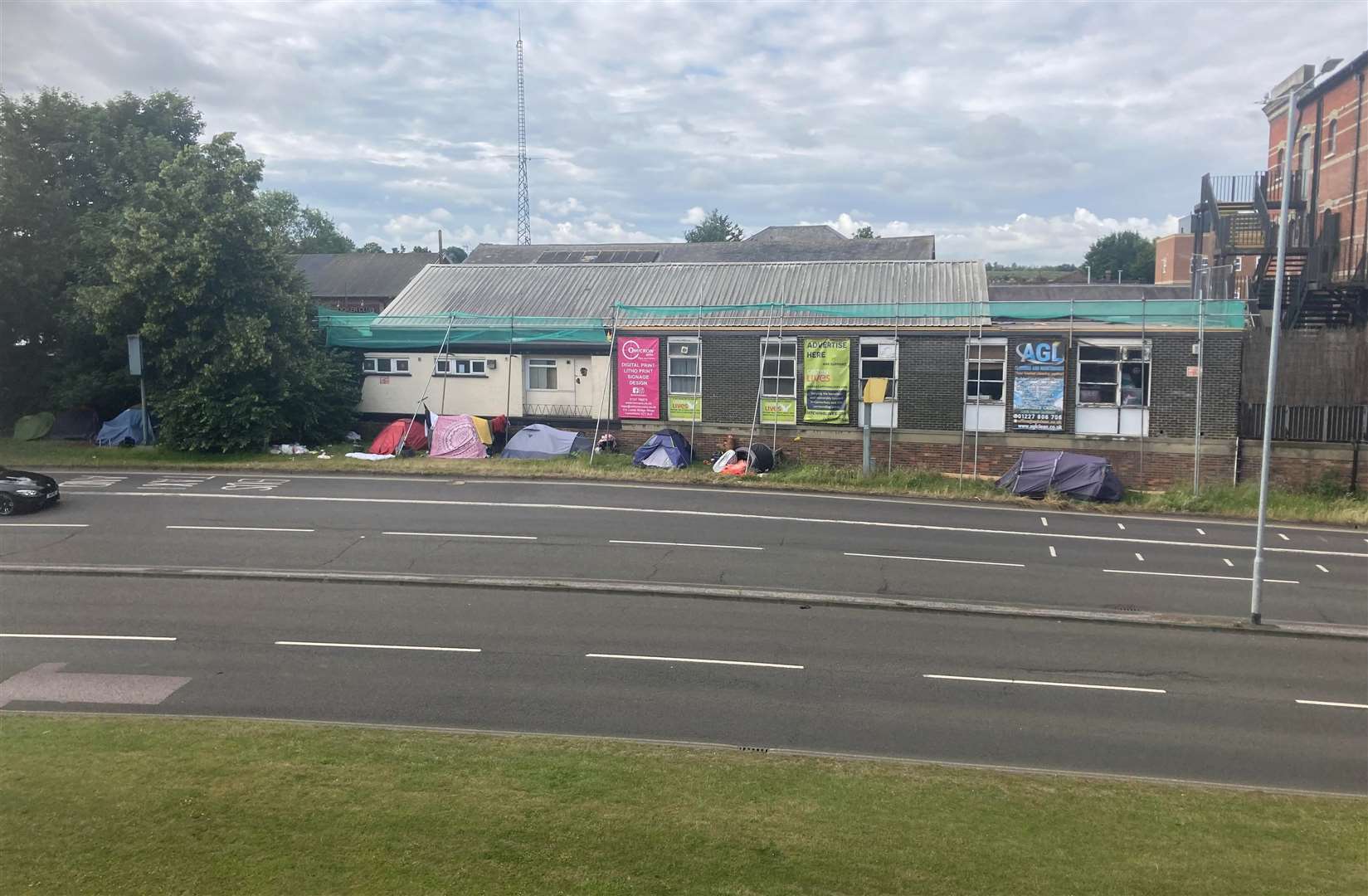 The homeless encampment on the edge of Canterbury's ring-road as seen from the city wall