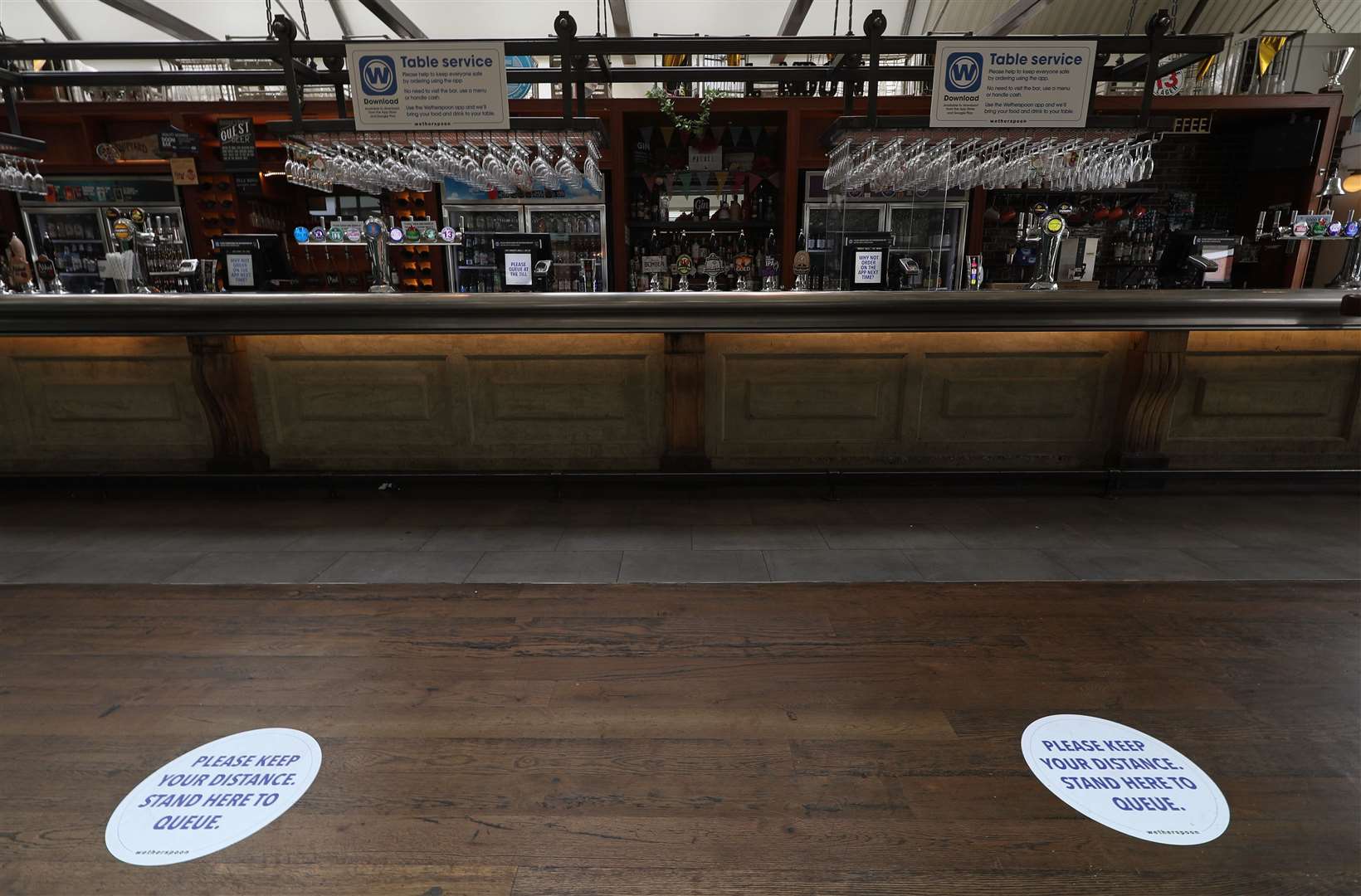 Social distancing signs on the floor of a Wetherspoons pub (Yui Mok/PA)