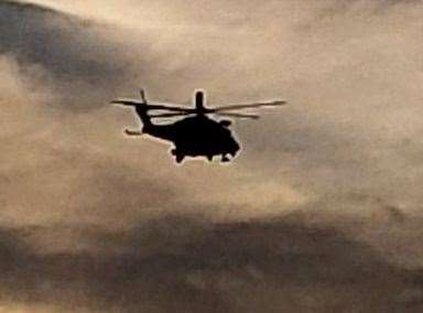 A coastguard helicopter searching the sea between Sandgate and Hythe