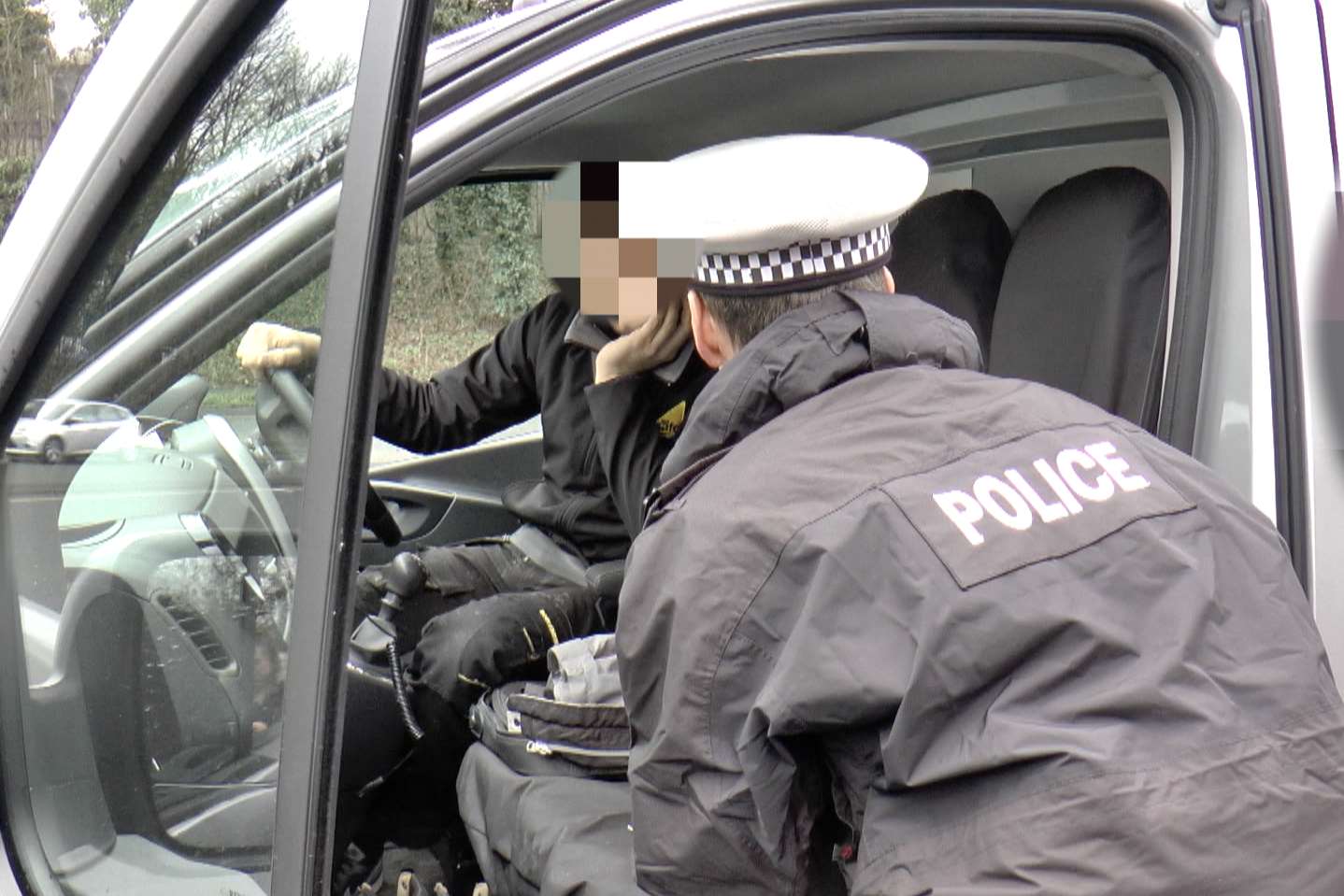 Police stop a driver who was using his mobile at the wheel. Stock pic.