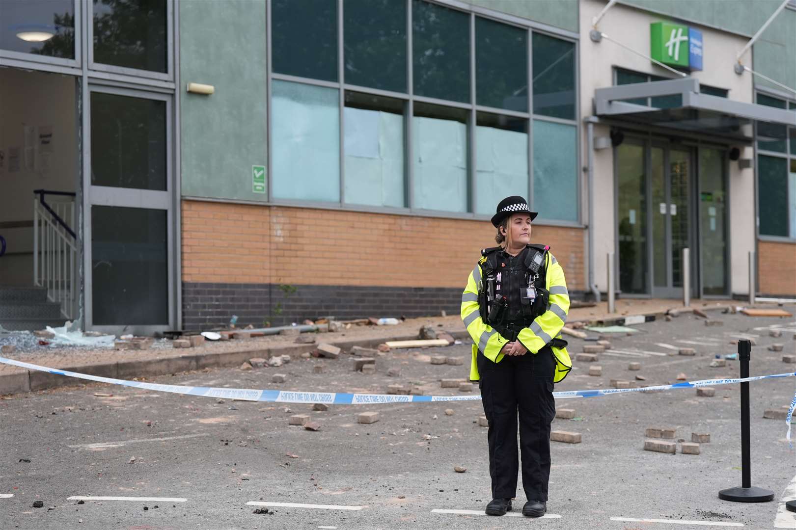 Police at the Holiday Inn Express in Tamworth after a mob attacked it on Sunday (Jacob King/PA)