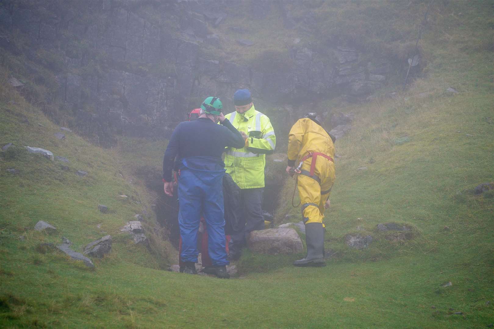 Rescuers at the entrance of the Ogof Ffynnon Ddu cave system near Penwyllt, Powys in the Brecon Beacons, Wales (Ben Birchall/PA)