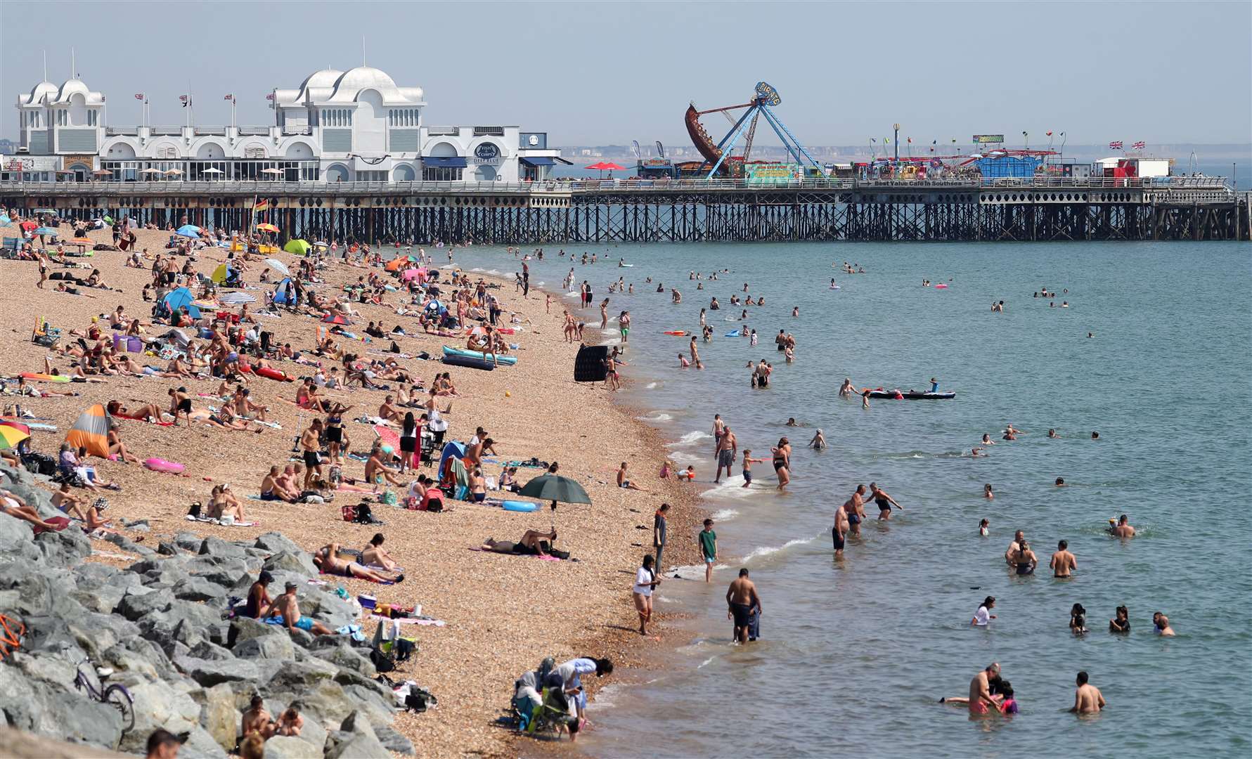 People enjoy the hot weather on Southsea beach in Hampshire on Tuesday (Andrew Matthews/PA)