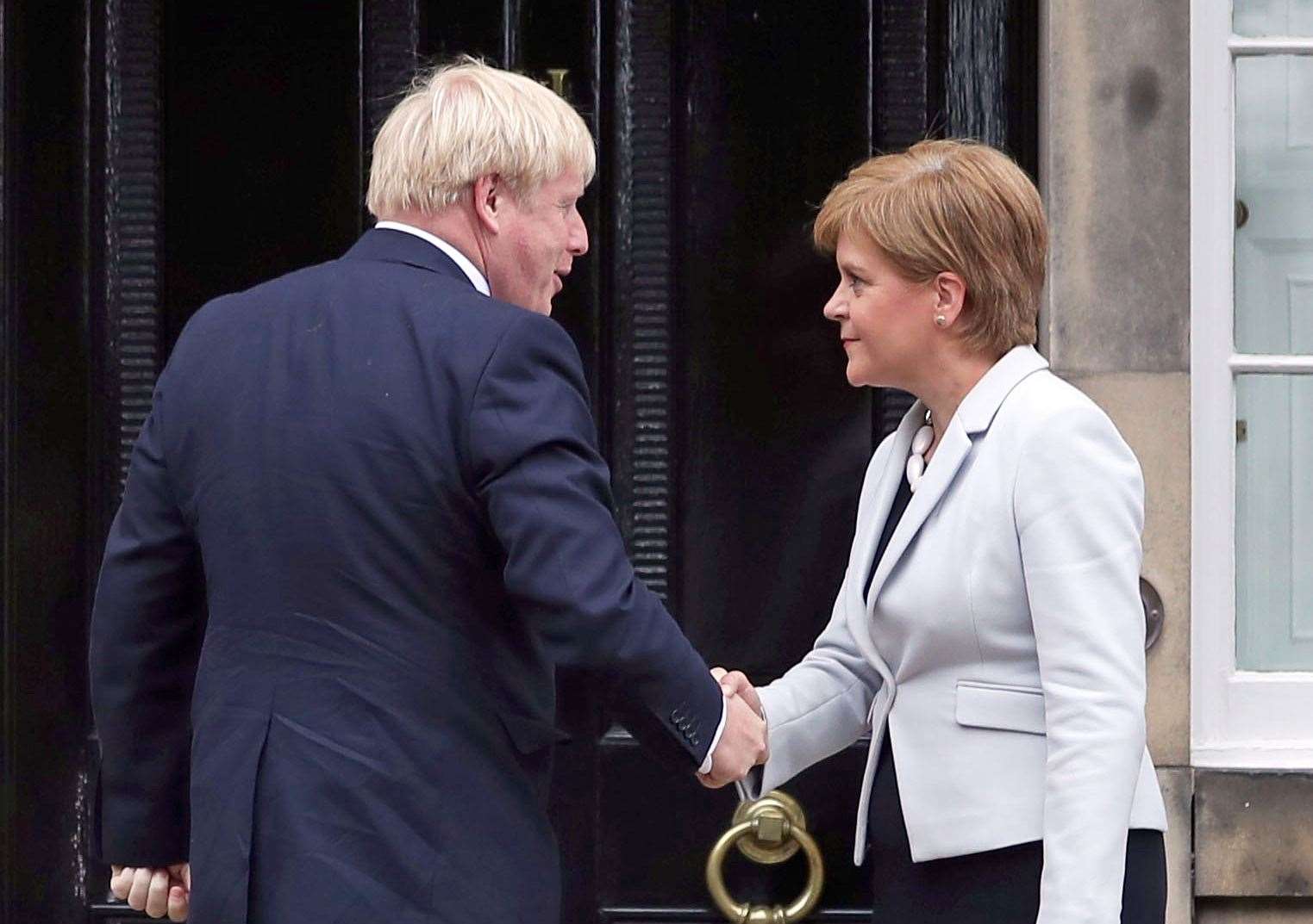 Ms Sturgeon welcoming Mr Johnson outside Bute House in Edinburgh last July (Jane Barlow/PA)