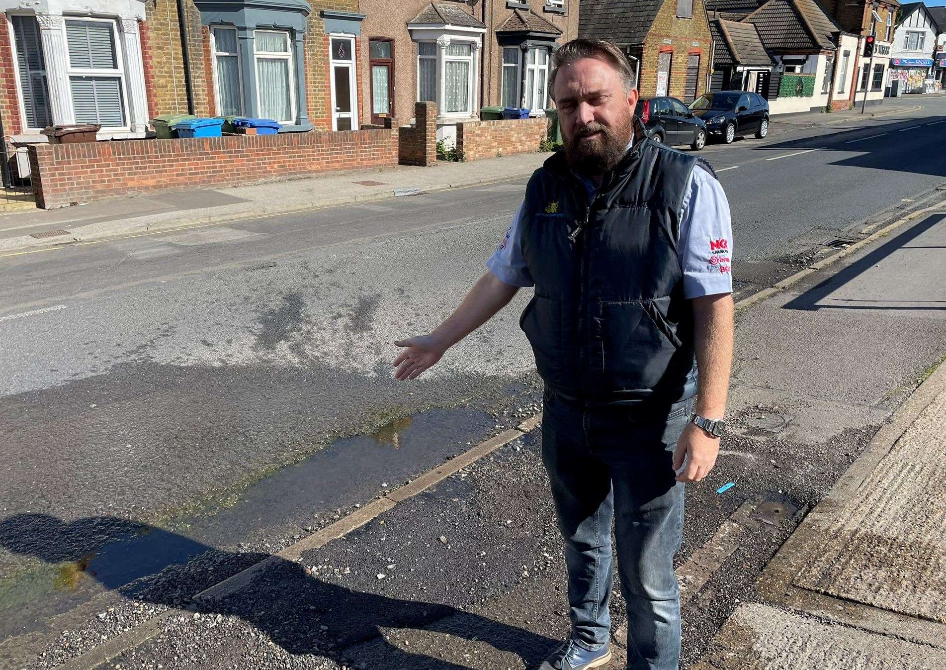 Branch manager of A2 Tyres Supplies Luke Stephens points to the water leak outside the premises in Queenborough Road, Sheppey. Picture: Joe Crossley