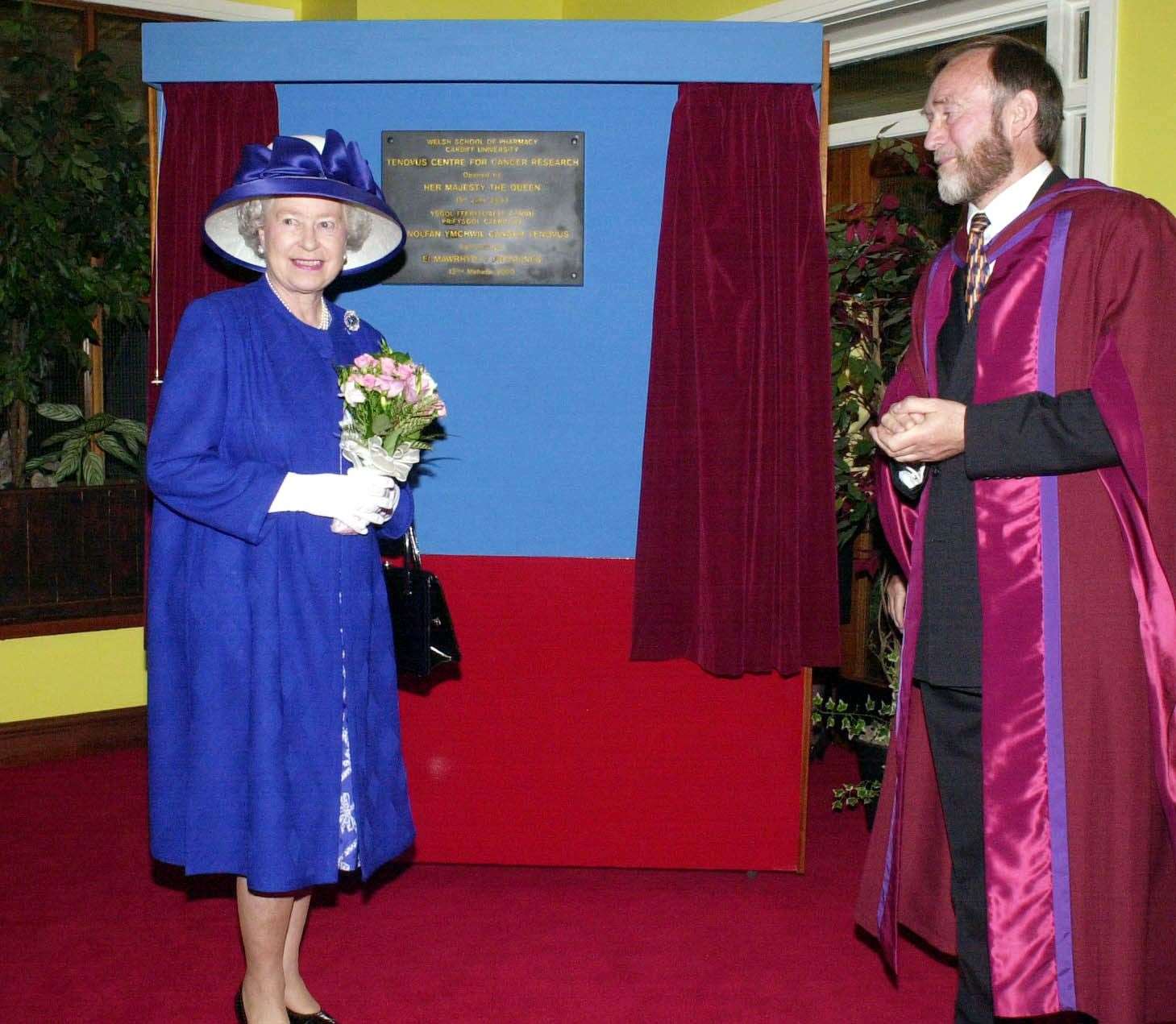 Queen Elizabeth II unveils a plaque to open the new Tenovus Laboratories at Cardiff University during a visit to the Welsh city. The Queen is pictured with Professor David Luscombe, head of the School of Pharmacy (Barry Batchelor/PA)