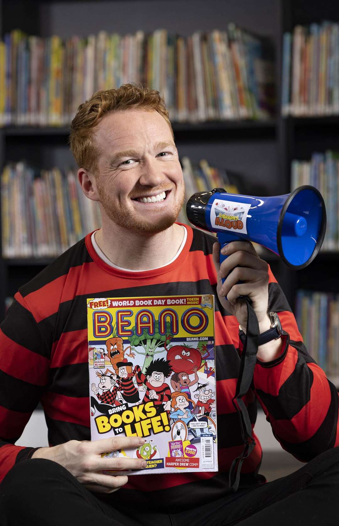 Olympic gold medallist Greg Rutherford reads from the ‘world’s loudest-ever comic strip’, which is part of a World Book Day edition of the Beano (Matt Alexander/PA))