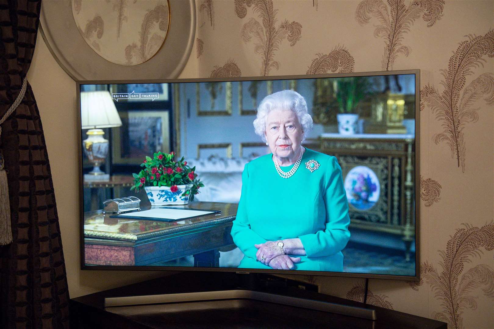 A family watches the Queen deliver her address to the nation and the Commonwealth on the pandemic (Jacob King/PA)