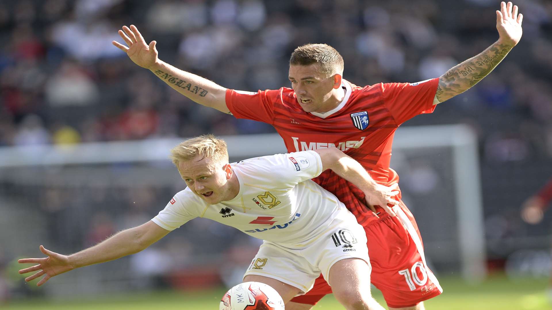 Cody McDonald battles with MK Dons' Ben Reeves Picture: Ady Kerry