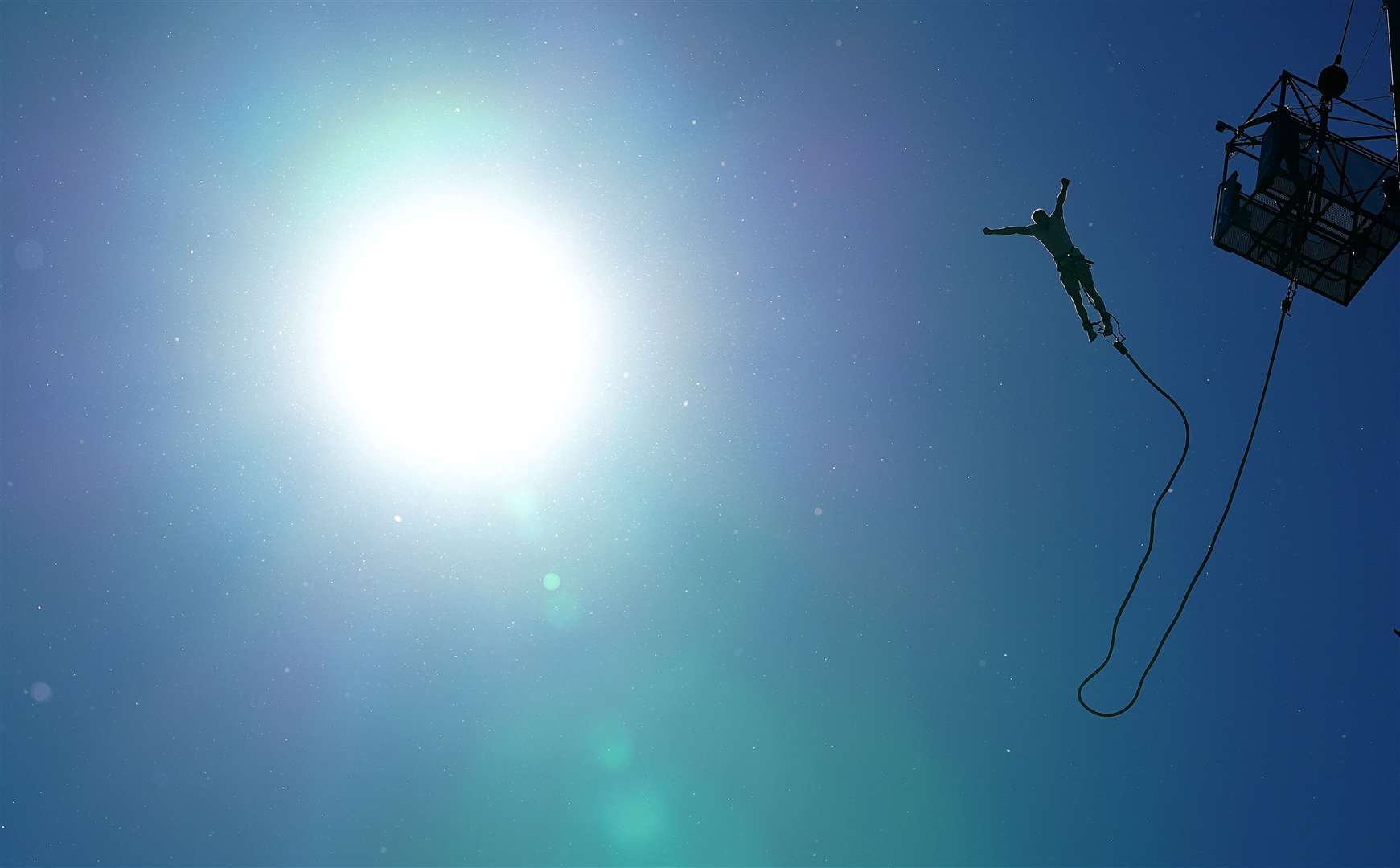 A person bungee jumps in Tatton Park (Martin Rickett/PA)