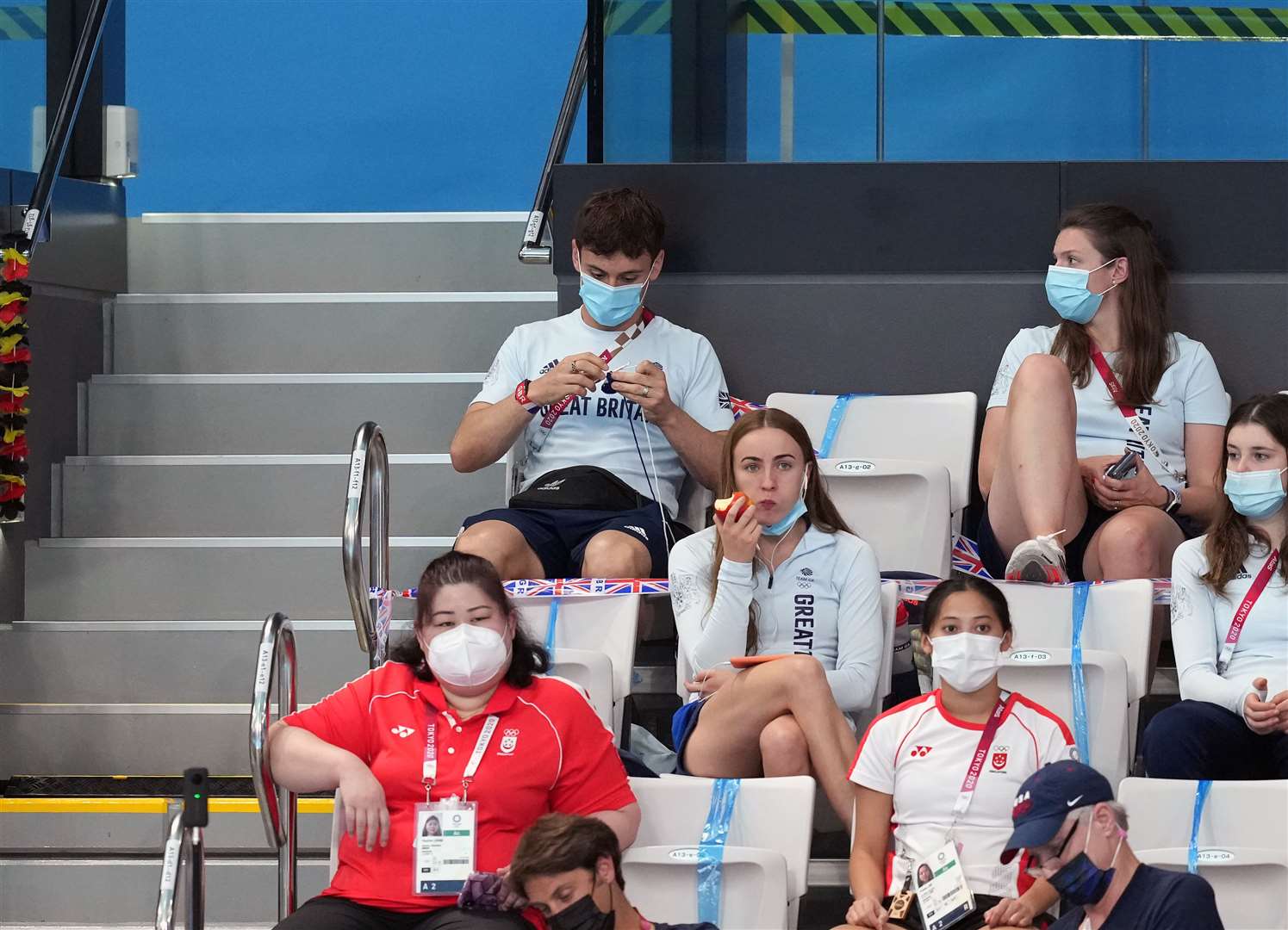 Daley knitting in the stands during the Tokyo Olympics three years ago (PA)