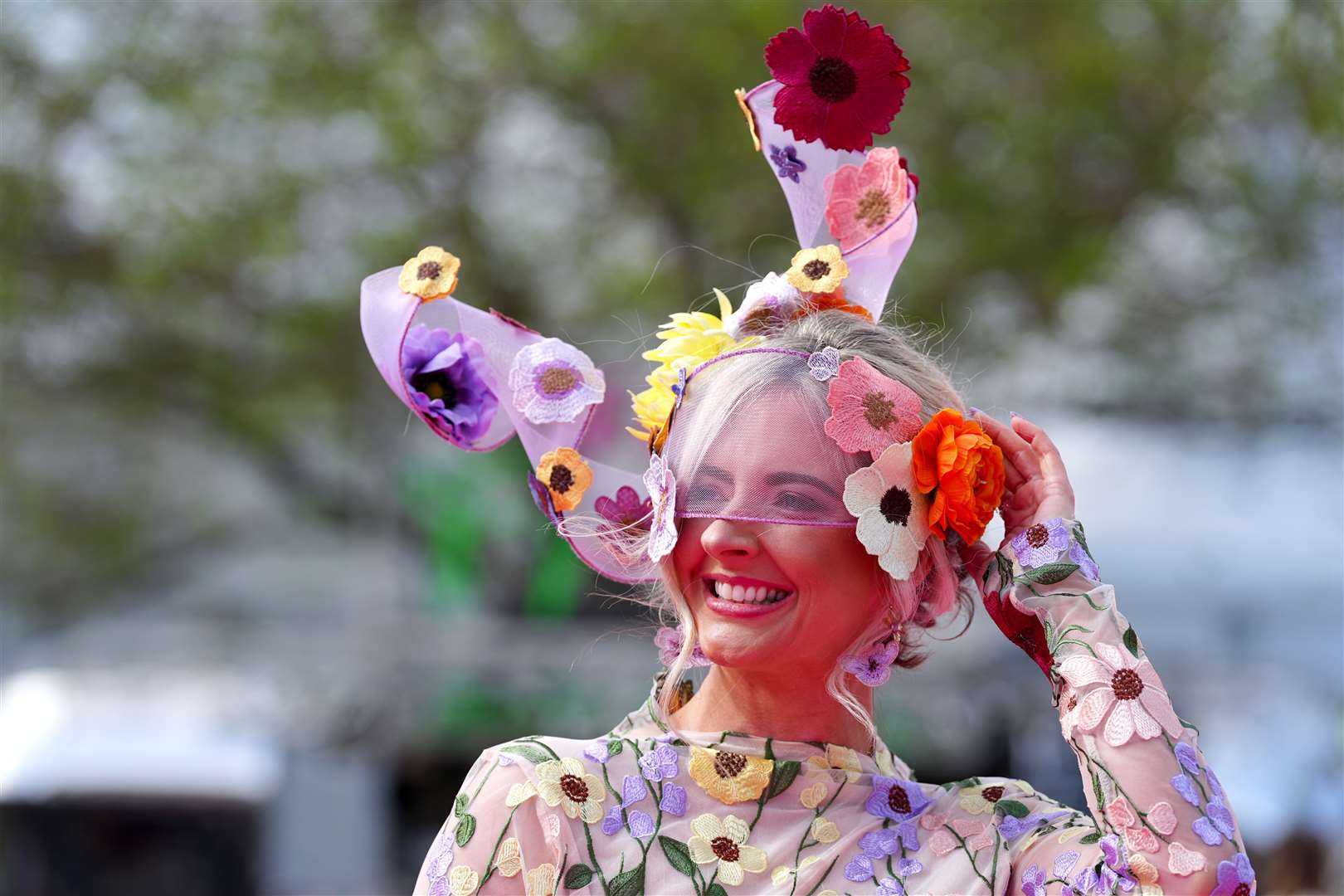 Fabric flowers adorned this racegoer’s headwear (Peter Byrne/PA)