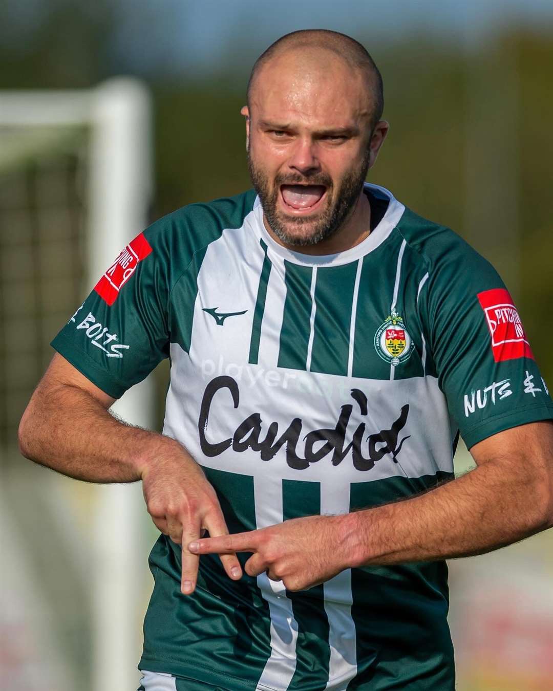 Ashford United striker Gary Lockyer celebrates one of his two goals against Hartley Wintney. Picture: Ian Scammell