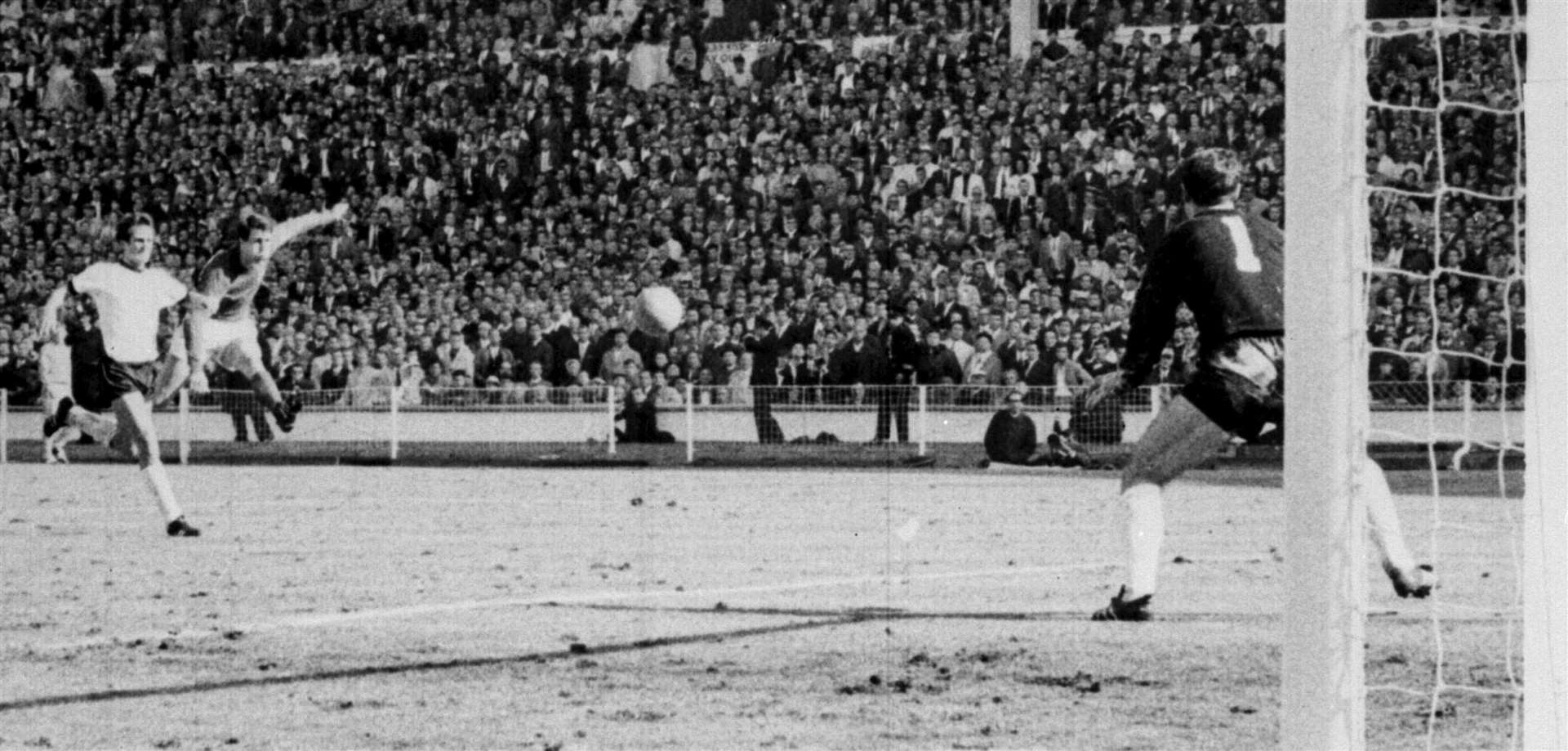 Geoff Hurst rifles a shot past goalkeeper Hans Tilkowski to complete his hat-trick