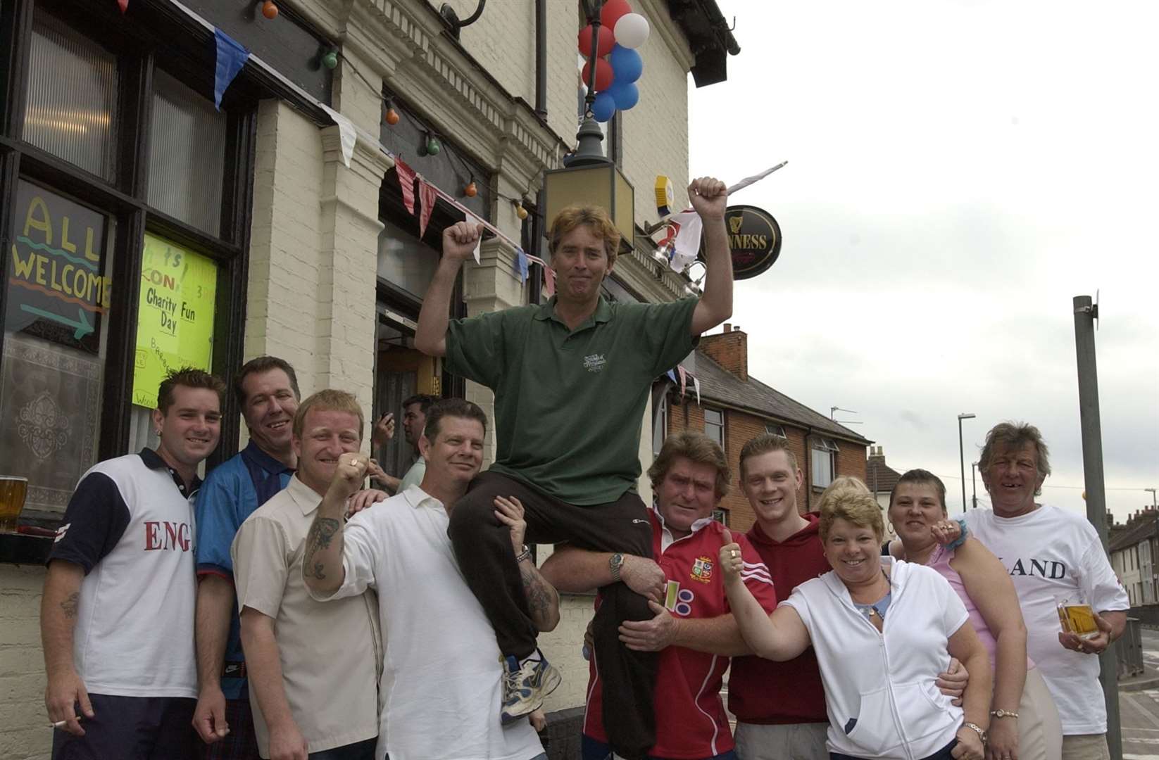Outside the Brickmakers Arms in Luton Road, Chatham, in June 2002. Held aloft is Brian Crawley who walked from Orpington to raise money. The pub is still going today