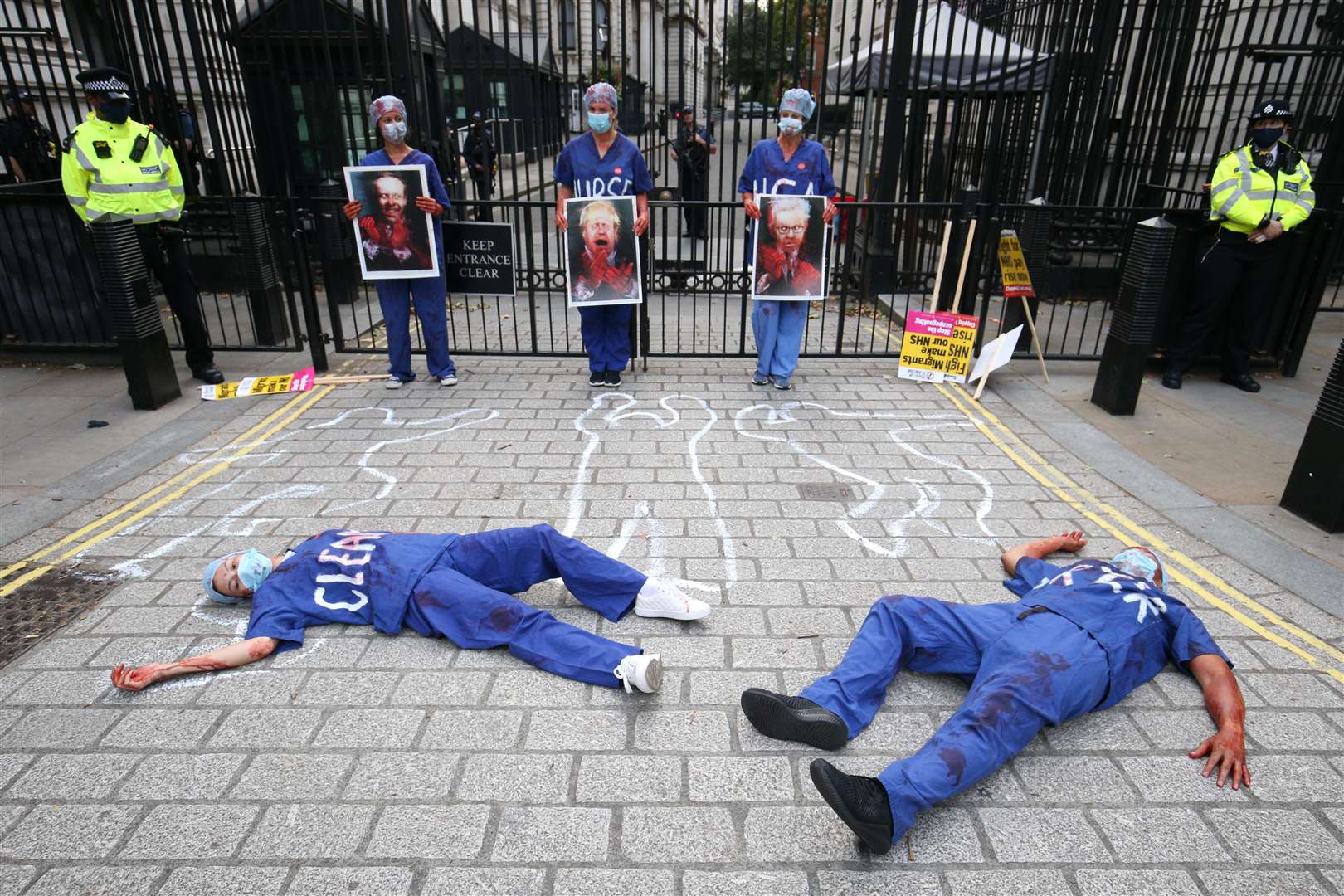 NHS workers stage a die-in outside Downing Street (Jonathan Brady/PA)