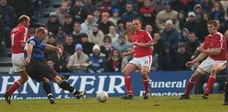 BIG MOMENT: Skipper Paul Smith fires home Gillingham's third