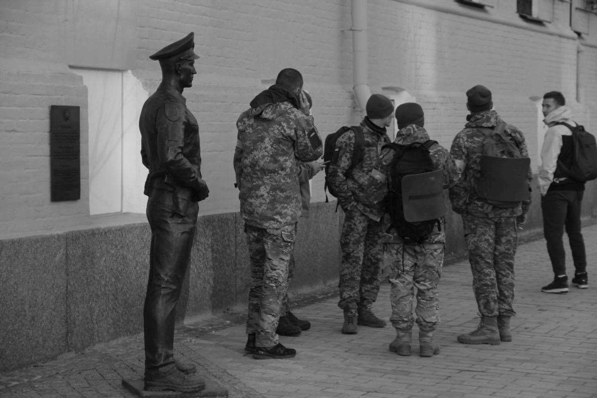 The black and white photographs, shot on a Canon 60D, depict Ukrainian soldiers, civilians and the destruction seen on the streets on her hometown (Maria Volkova/PA)