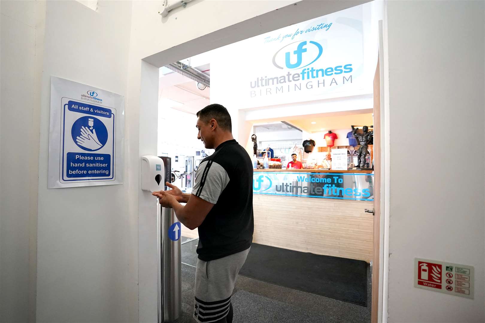 Gym members are seen sanitising their hands between reps (Morgan Harlow/PA)