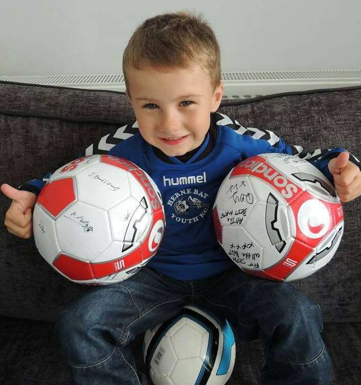 Connor with his Herne Bay Youth FC shirt and signed footballs