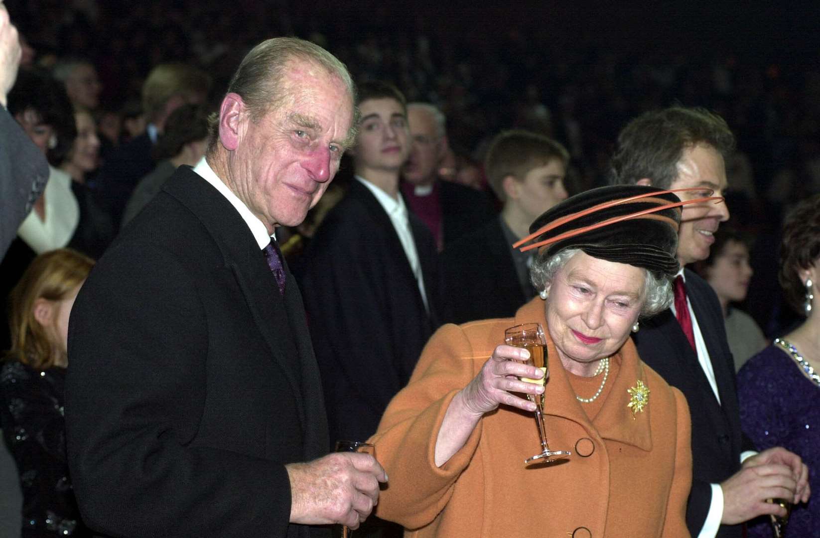 The Queen and the Duke of Edinburgh raise their glasses as midnight strikes during the Millennium Dome opening celebrations, at the turn of the year 2000 (Fiona Hanson/PA)