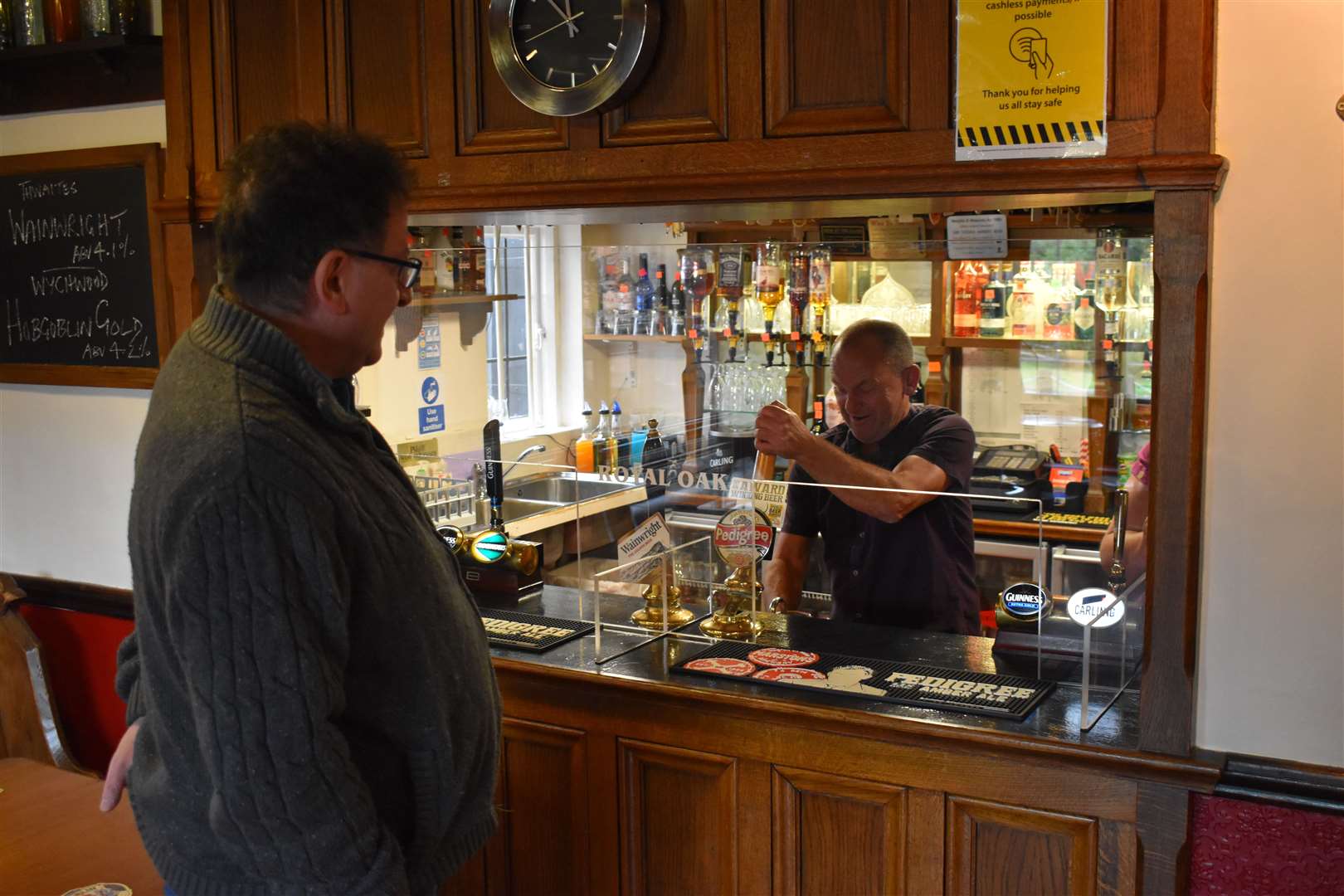 The Campaign for Real Ale’s national chairman Nik Antona waits at the bar at the Royal Oak in Barton-under-Needwood, Staffordshire, as landlord Steve Boulter pulls a pint of bitter (Matthew Cooper/PA)