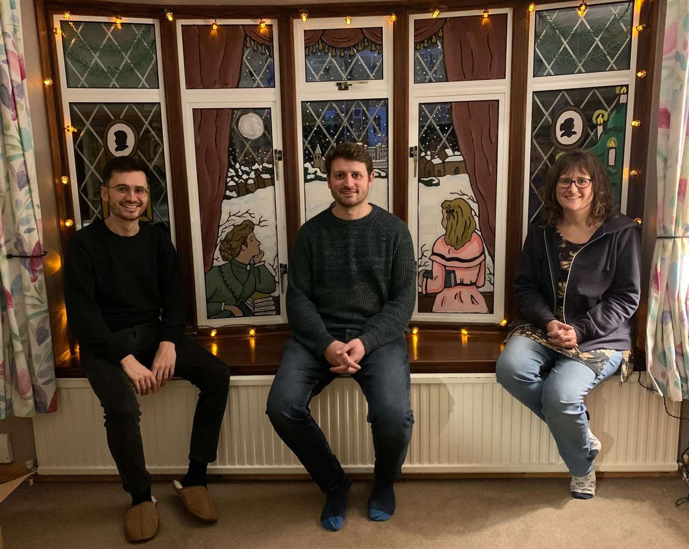 Jonathan, Neil and Melanie with previous window displays at the family home in Rochester. Picture: Janita King