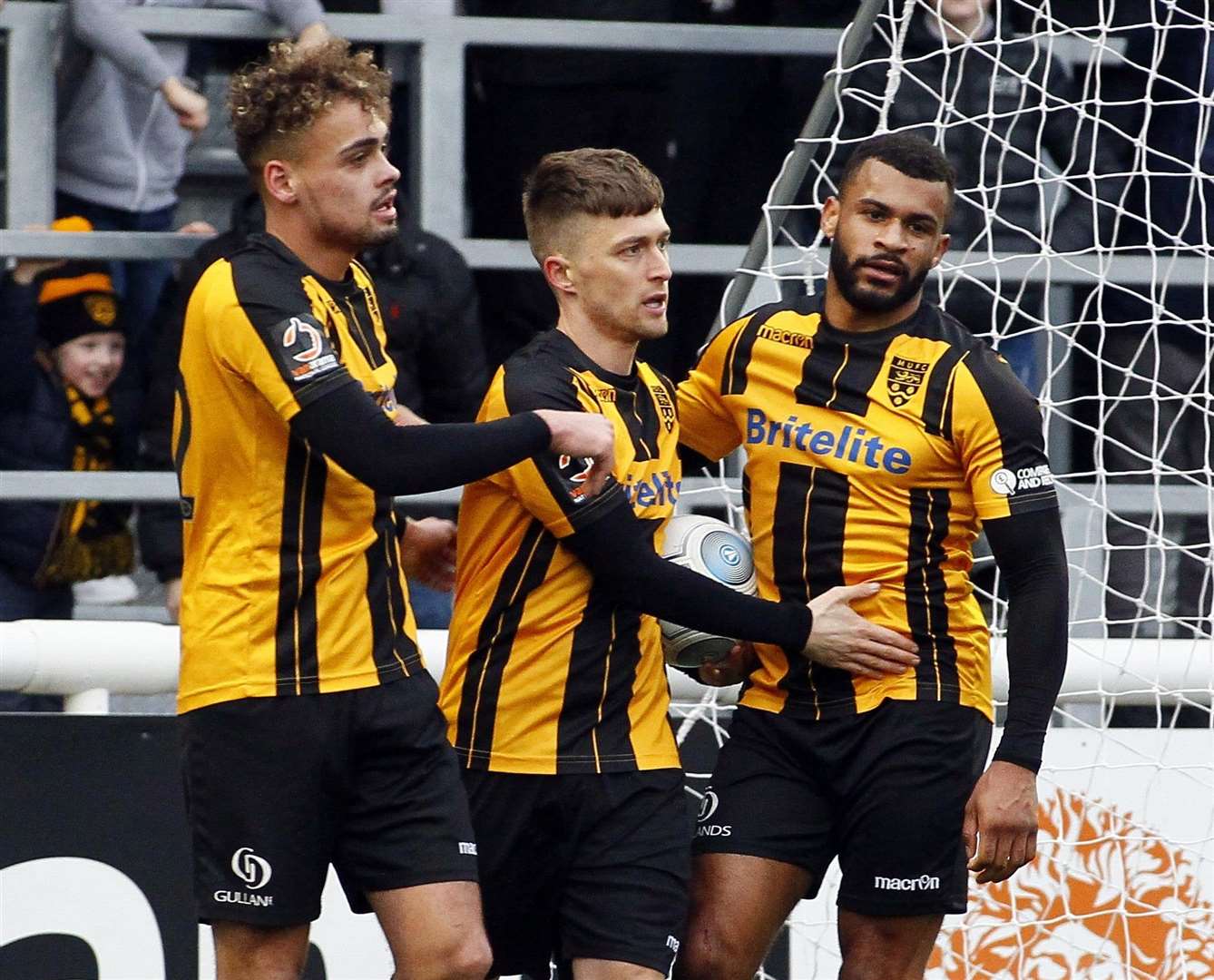 Jake Robinson, centre, with Michael Phillips and Dan Wishart after forcing Maidstone's own-goal equaliser .Picture: Sean Aidan