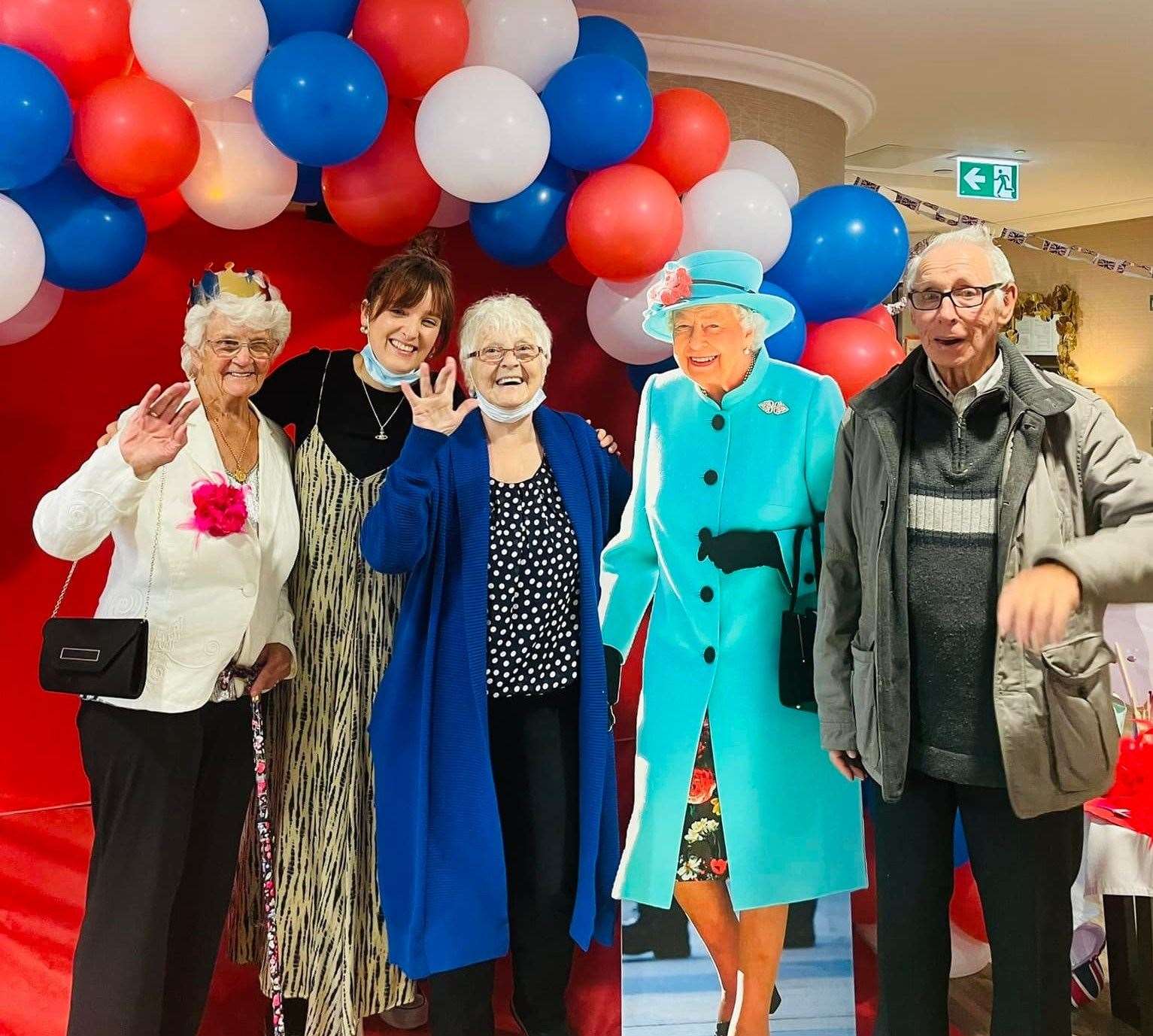 The 21-year-old posing with residents Lillian, Pauline and Arthur at the Invicta Court Jubilee party. Picture: Abby Wincel