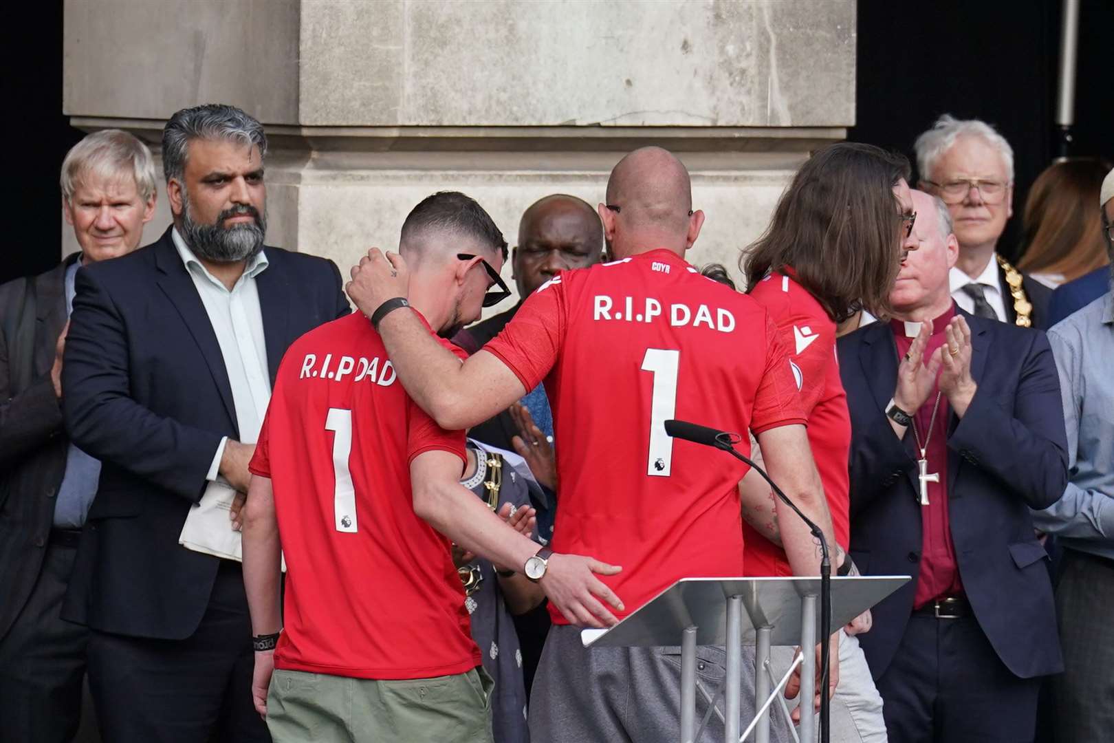 Ian Coates’ sons during a vigil in Old Market Square, Nottingham, following the attacks (Tim Goode/PA)