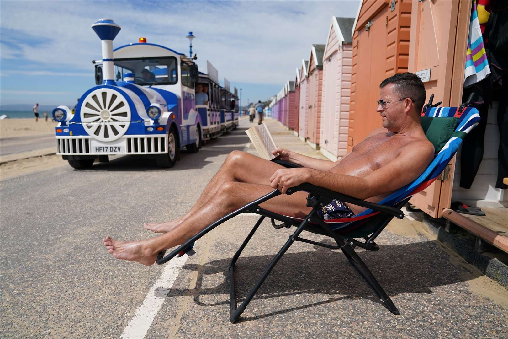 Stuart Henderson enjoys sunshine from his hut on Bournemouth beach (Andrew Matthews/PA)