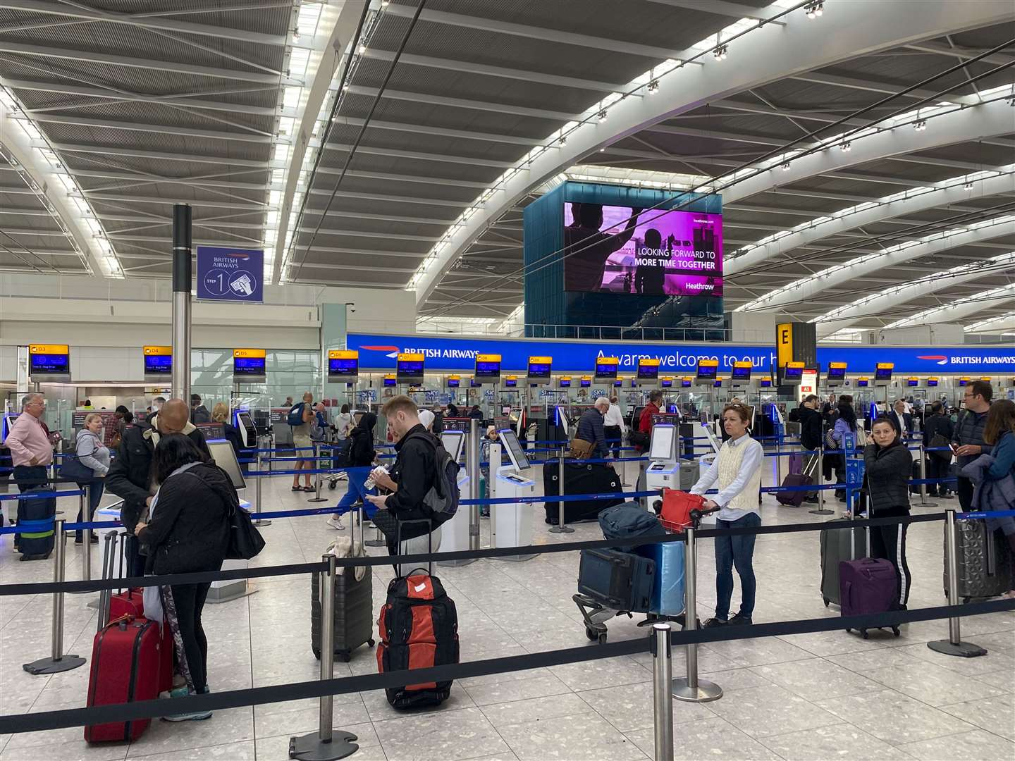 Passengers queueing to check-in bags in departures at Terminal 5 at Heathrow Airport (Steve Parsons/PA)