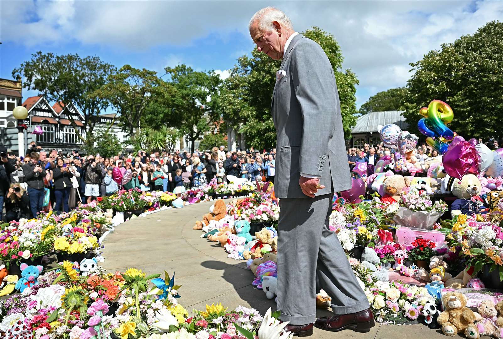 Charles walked among hundreds of bunches of flowers and cuddly toys left as tributes (Paul Ellis/PA)