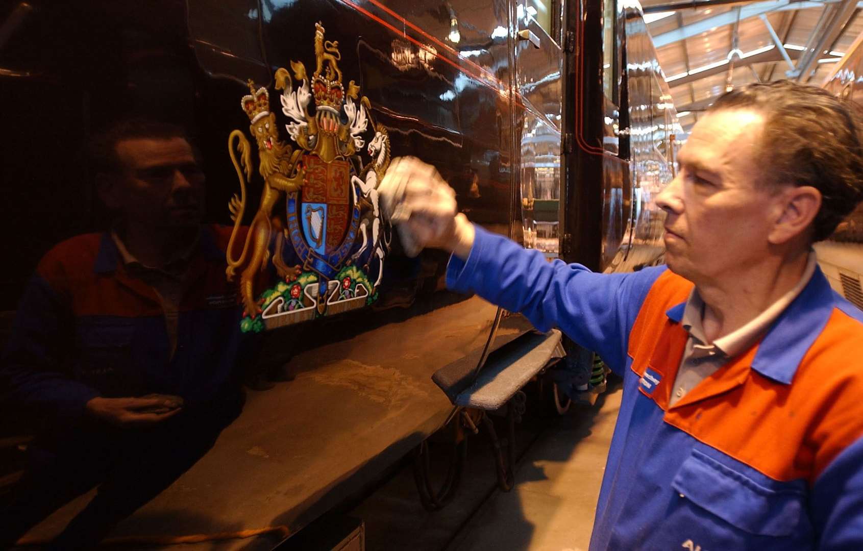 A worker polishes the outside of the Royal Train (Matthew Fearn/PA)