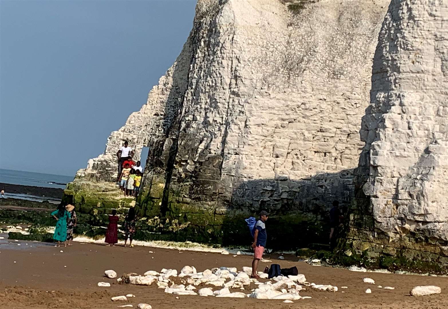 A family huddled on the sea stack to snap a group picture